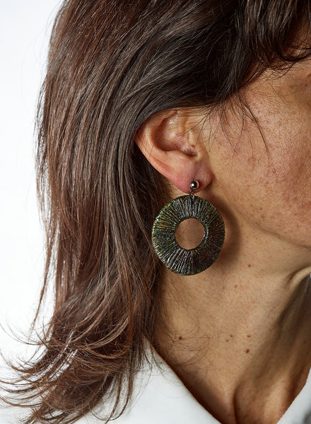 Orecchini fatti a mano in ceramica raku a forma di  disco cavo con fitti raggi sottili e gancio a perno semicircolare