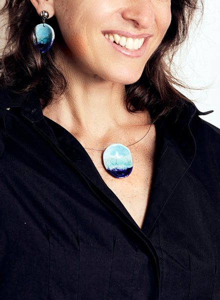 Collana artigianale con pendente ovale in ceramica Raku nei toni dell’azzurro e del blu profondo.
