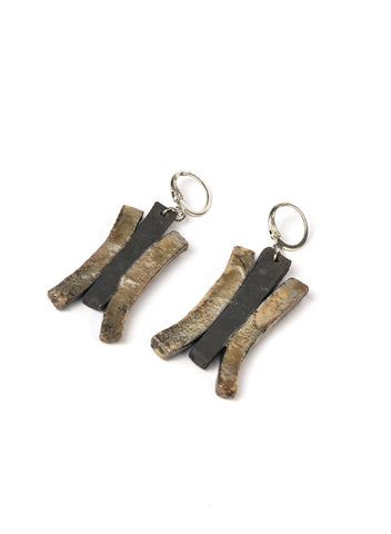 Orecchini con pendente in ceramica Raku con strisce oro cangiante che si appoggiano su una base nero fumo